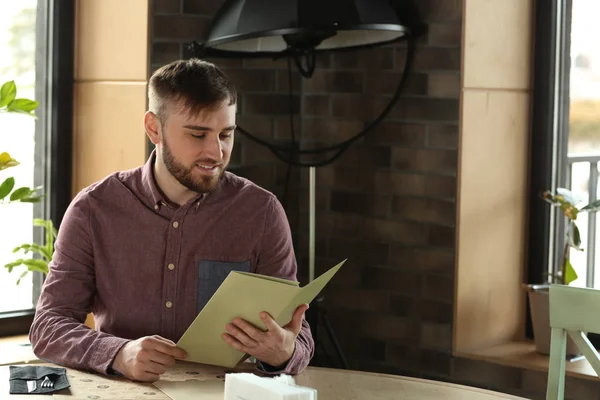 Young Man Sitting Table While Reading Menu Restaurant — Stock Photo, Image