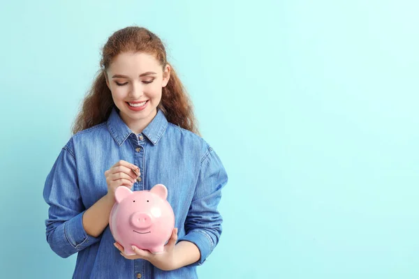 Woman Putting Coin Piggy Bank Color Background Money Savings Concept — Stock Photo, Image