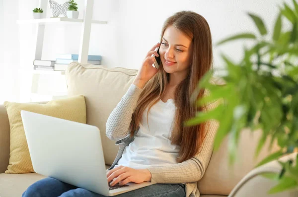 Female Freelancer Talking Phone While Working Laptop Home — Stock Photo, Image