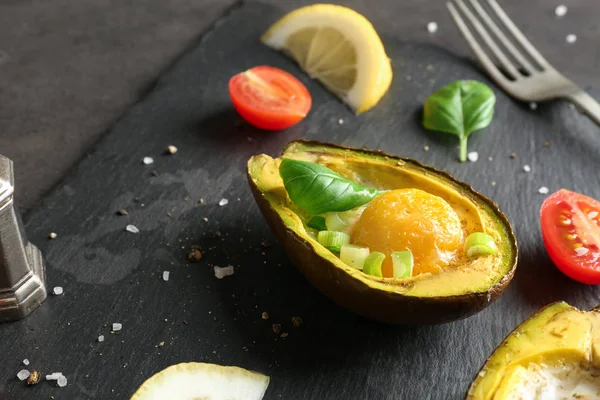 Avocado baked with egg on table