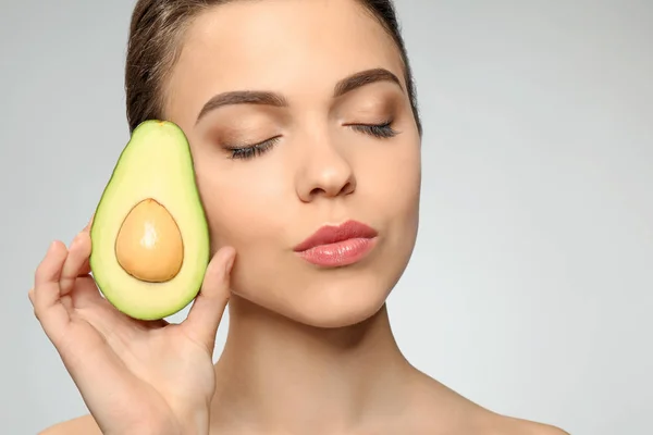 Beautiful Young Woman Avocado Light Background — Stock Photo, Image