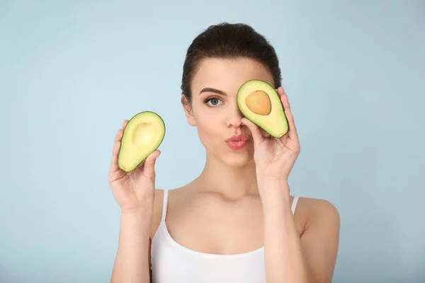 Schöne Junge Frau Mit Avocado Auf Farbigem Hintergrund — Stockfoto