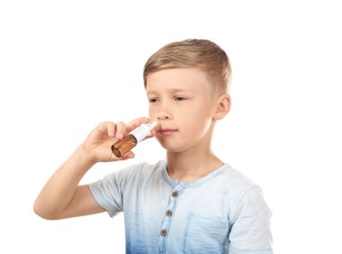 Little boy using nasal drops on white background. Allergy concept clipart