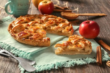 Tasty homemade apple pie on wooden table clipart