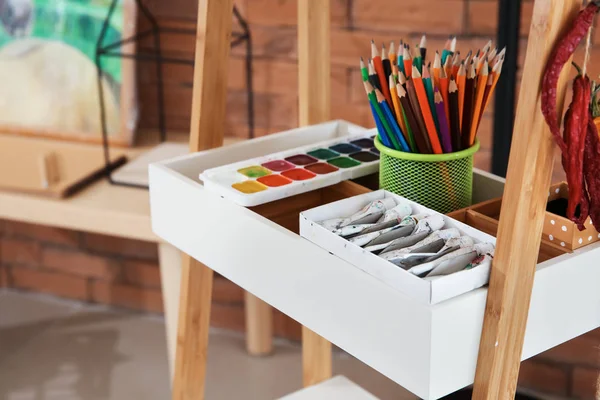Different paints with pencils in artist's workshop