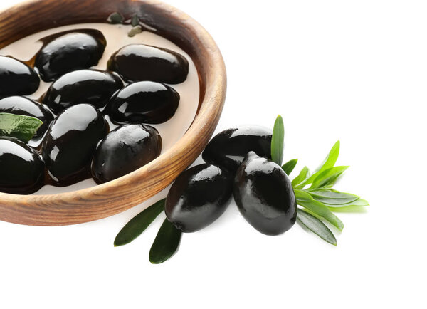 Bowl with oil and black olives on white background