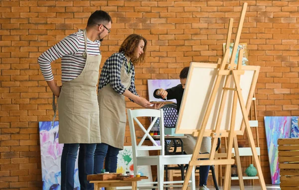 Group of people during classes in school of painters