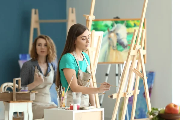 Female student during classes in school of painters
