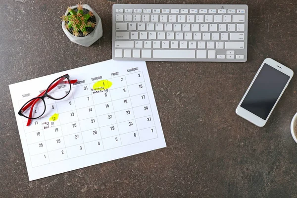 Composition of calendar with notes, computer keyboard and phone on grey background