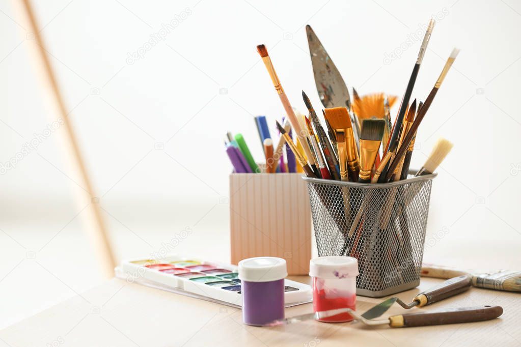 Tools and paints of professional artist on table