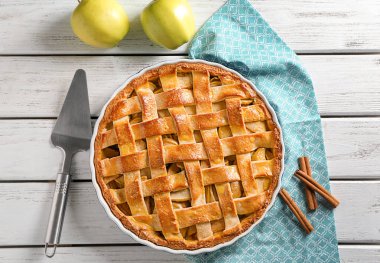 Composition with delicious apple pie on wooden background clipart