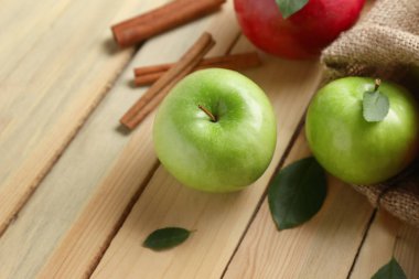 Taze olgun elma ve tarçın ahşap arka plan üzerinde