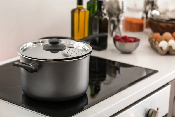 Electric stove with stewpan in kitchen