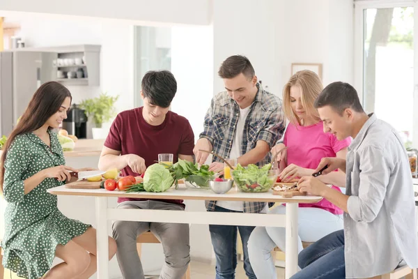 Friends cooking together in kitchen