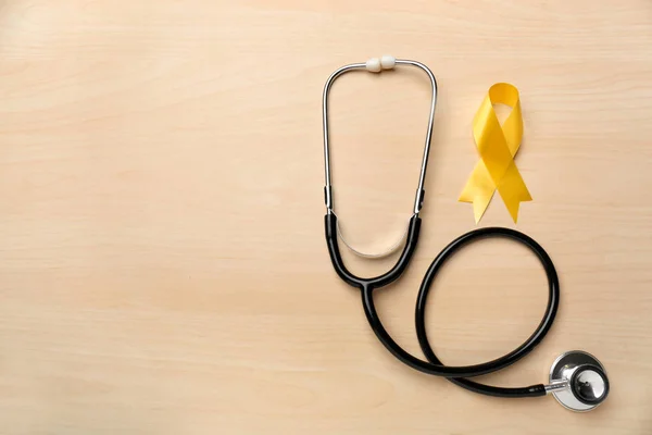 Yellow Ribbon Stethoscope Light Background Cancer Concept — Stock Photo, Image