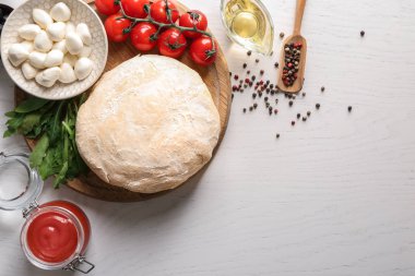 Çiğ hamur ve malzemeler için açık renkli pizzaya kompozisyonu