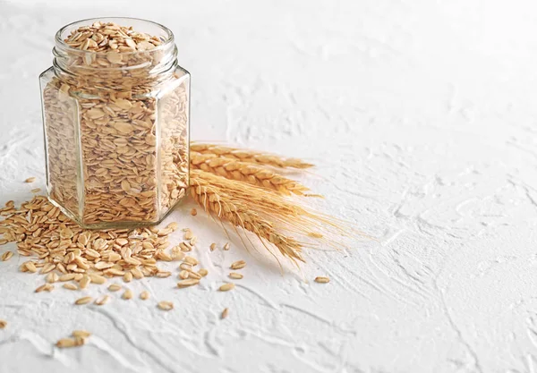 Glass Jar Raw Oatmeal Light Background — Stock Photo, Image