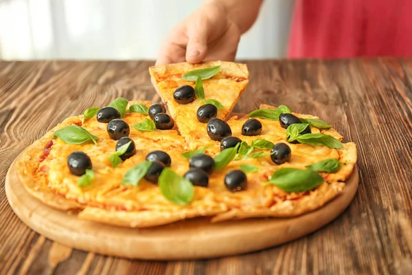 Woman Taking Slice Tasty Pizza Olives Wooden Table — Stock Photo, Image