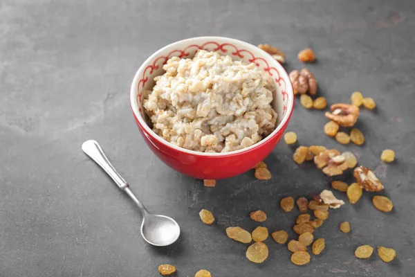 Bowl Tasty Oatmeal Raisins Walnuts Grey Background — Stock Photo, Image