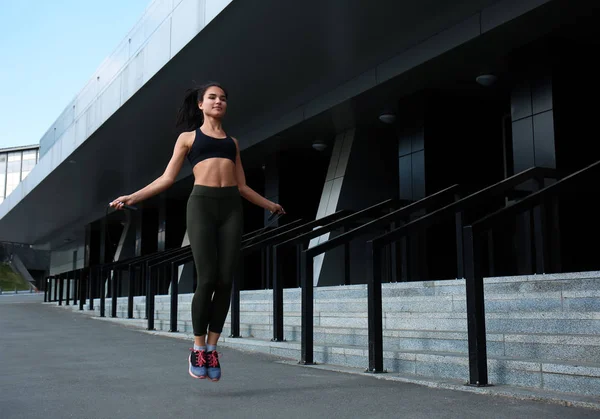 Sporty Young Woman Jumping Rope Outdoors — Stock Photo, Image