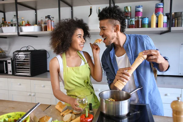 Young African American Couple Tasting Food While Cooking Together Kitchen — Stock Photo, Image