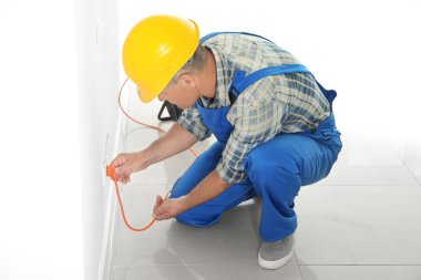 Erkek elektrikçi, bakım kolaylığı kontrol için prize tak ekleme