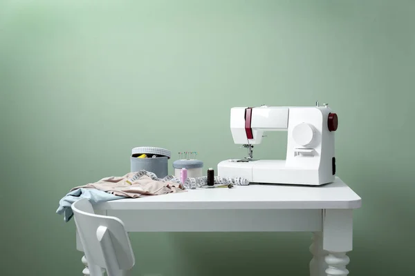 Nähmaschine Mit Schneiderzubehör Auf Dem Tisch Vor Farbigem Hintergrund — Stockfoto