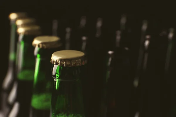 玻璃瓶冷啤酒在黑暗的背景 — 图库照片