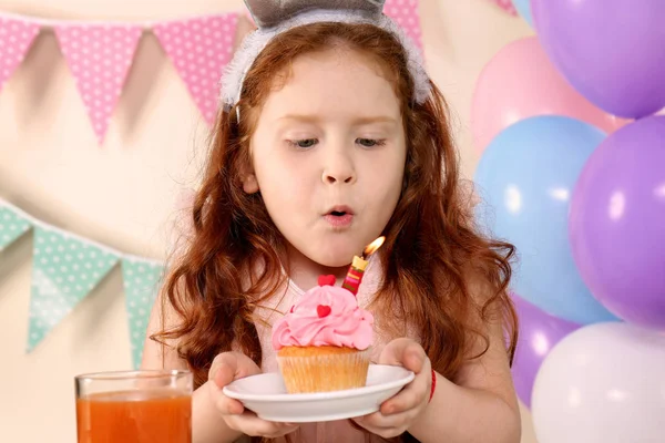 Little Girl Blowing Out Candle Birthday Cupcake Home — Stock Photo, Image