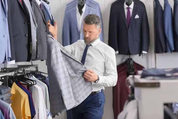 Handsome Mature Man Choosing Stylish Suit Menswear Store — Stock Photo, Image