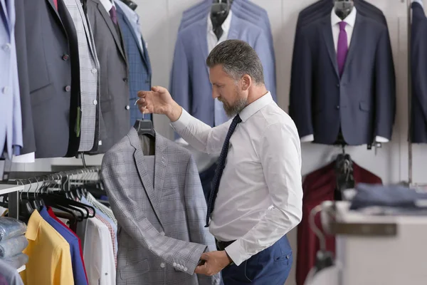 Handsome Mature Man Choosing Stylish Suit Menswear Store — Stock Photo, Image