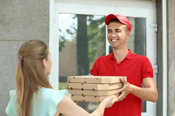 Young Man Giving Pizza Boxes Woman Outdoors Food Delivery Service — Stock Photo, Image
