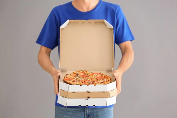 Junger Mann Mit Pizzakartons Auf Grauem Hintergrund Essenslieferdienst — Stockfoto