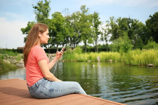 Young Woman Listening Music Wooden Bridge River — Stock Photo, Image