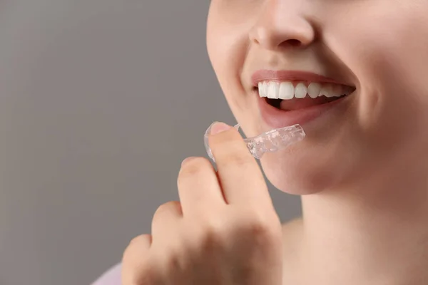 Woman Putting Occlusal Splint Mouth Grey Background Closeup — Stock Photo, Image