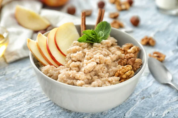 Elma ve ceviz masada kase lezzetli yulaf ezmesi