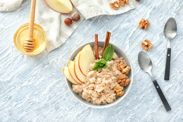 Elma ve ceviz masada kase lezzetli yulaf ezmesi