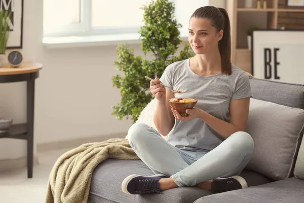 Beautiful Young Woman Eating Tasty Oatmeal Home — Stock Photo, Image