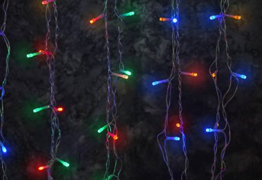 Koyu arka plan üzerinde parlayan Noel çelenk