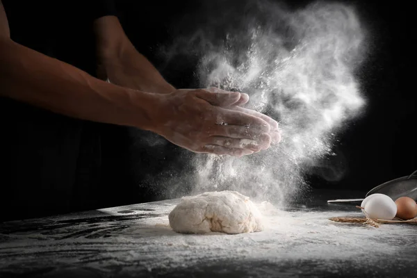 Man Clapping Hands Sprinkling Flour Dough Black Background — Stock Photo, Image