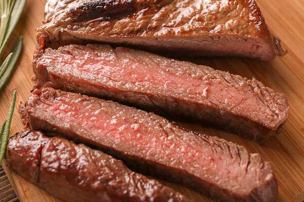 Tasty cut steak on board, closeup