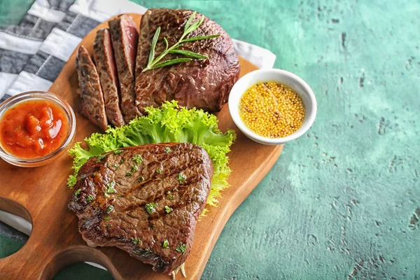 Board Tasty Steaks Herbs Sauces Green Background — Stock Photo, Image