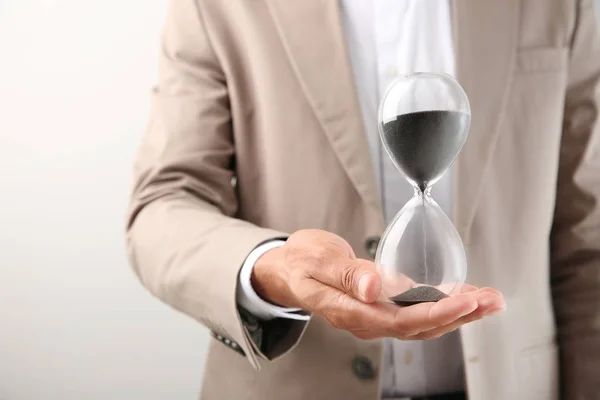 Businessman Holding Hourglass Light Background Closeup Time Management Concept — Stock Photo, Image
