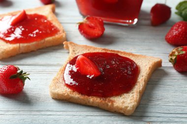 Ahşap masa, closeup üzerinde çilek reçeli ile tost
