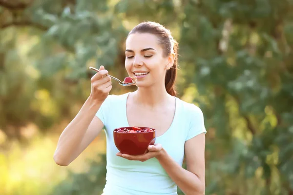 Young Woman Eating Tasty Oatmeal Outdoors — Stock Photo, Image