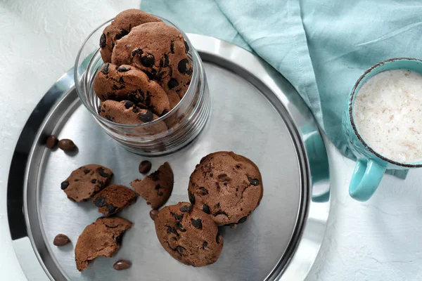 Metal tray with delicious chocolate cookies on white table