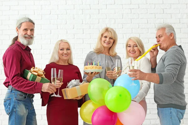 Mature People Celebrating Birthday Tasty Cake Champagne Brick Wall Background — Stock Photo, Image