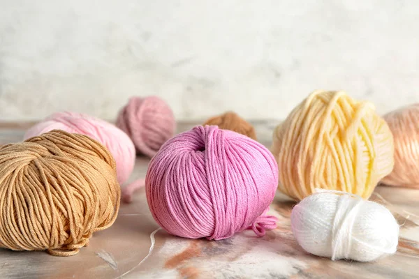 Balls of knitting yarn on color table