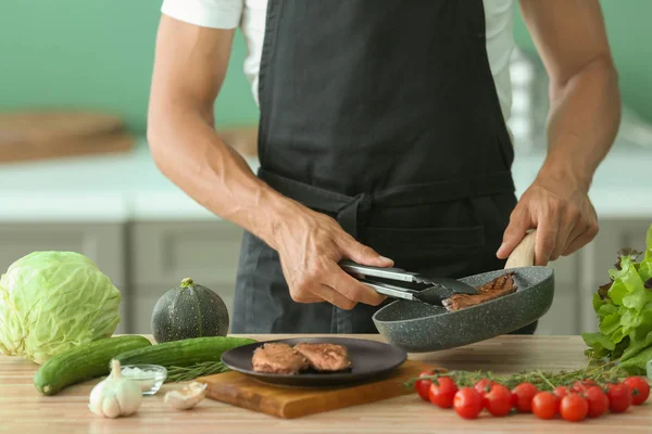 Man Putting Delicious Roasted Meat Plate Kitchen — Stock Photo, Image