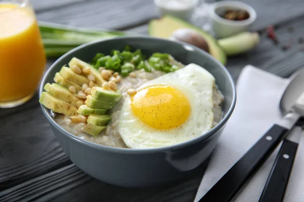 Bowl Delicious Oatmeal Egg Avocado Wooden Table — Stock Photo, Image